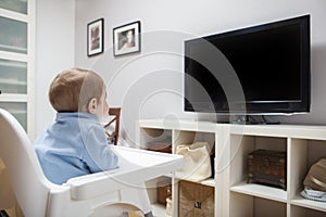 Baby boy watching television in living room