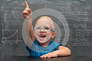 Baby boy wearing glasses with a clever look.