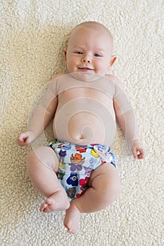 A baby boy wearing a reusable all in one nappy photo