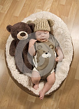 Baby Boy Wearing A Teddy Bear Hat and Romper photo