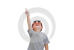 Baby boy wearing a telescope glasses point finger and looking up over white background isolated. Kid and adventure concept