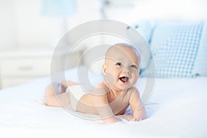 Baby boy on white bed