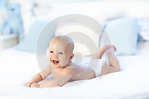 Baby boy on white bed