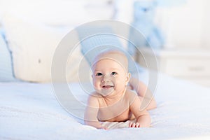 Baby boy on white bed