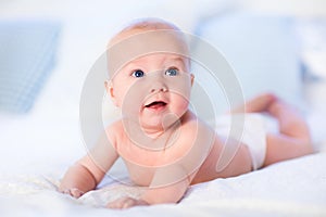 Baby boy on white bed