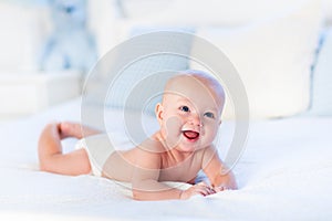 Baby boy on white bed