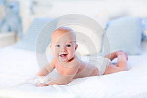 Baby boy on white bed