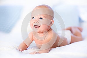 Baby boy on white bed