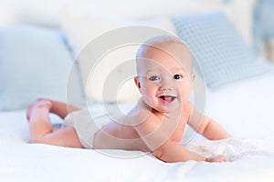 Baby boy on white bed