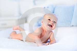 Baby boy on white bed