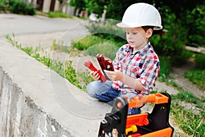 Baby boy in white construction helmet