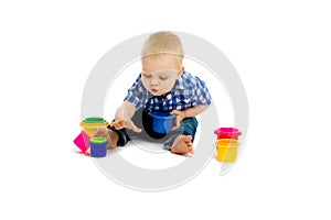 Baby boy on a white floor with toys