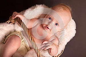 Baby boy in wicker basket