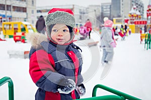 Baby boy on a winter playground