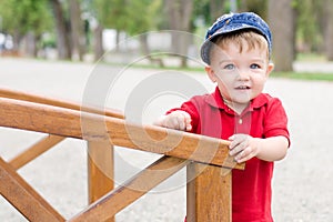 Baby boy on wooden bridge