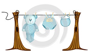 Baby boys clothing with teddy bear on clothesline