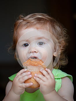 Baby with bread. Cute toddler child eating sandwich, self feeding concept.