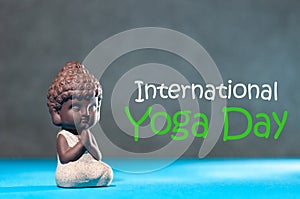 Baby Buddha with his hand in greeting sign namaste and concept of the International Yoga Day