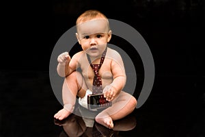 Baby businessman holding cell phone