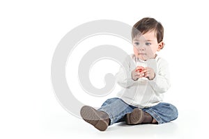 Baby with a candy in her hands