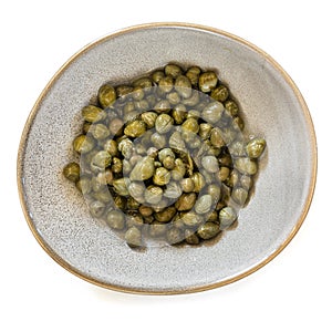 Baby Capers in Stoneware Bowl Top View Isolated on White photo
