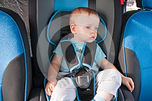 Baby in car seat for safety, looking outside