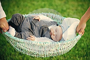 Baby care. Baby boy sleep in crib held in hands