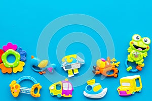 Baby care with craft toys for newborn. Rattle. Blue background top view copy space