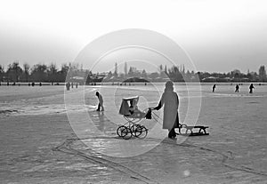 Baby carriage and sledge on the frozen Old Danube