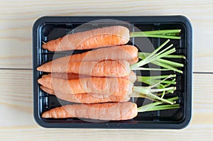 Baby carrots in a black container