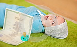 Baby with certificate of birth