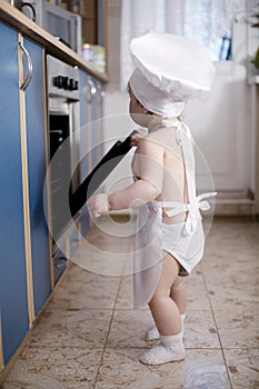 Baby chef cooks in the oven food