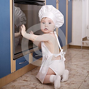 Baby chef cooks in the oven food