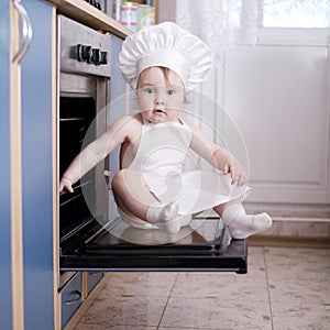 Baby chef cooks in the oven food