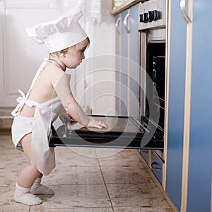 Baby chef cooks in the oven food