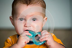 Baby chewing on teething ring