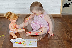 Baby child draws with colored paints hands, dirty feet and fingers. Child artistic experiences. Little artist