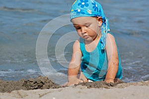 Baby child playing in waves