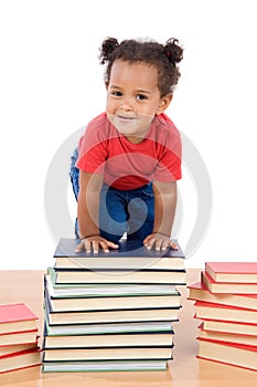 Baby climb up over a pile of books