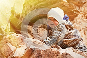 Baby climbing on a rock