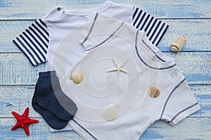 Baby clothers on Shabby Chic blue and white wooden background with textured scratches and antique cracked paint
