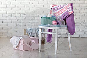 Baby clothes on chair in white room