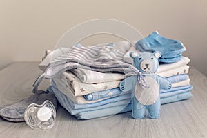 Baby clothes with diapers are stacked photo