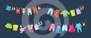 Baby clothes hanging on clothesline. Drying children`s clothes and accessories after washing on rope. Shorts, socks, romper