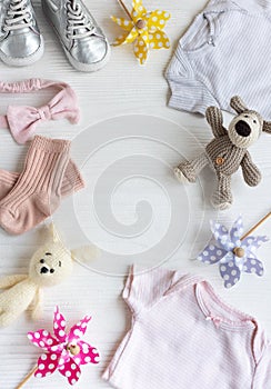 Baby clothes with knitted toys dog and rabbit, toy windmills and baby shoes and accessories