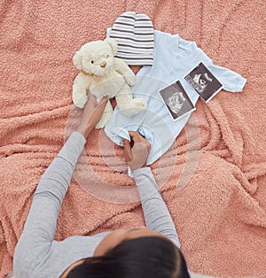 Baby clothes, scan and pregnant woman preparing for her child or infant in the nursery or bedroom. Pregnancy, love and