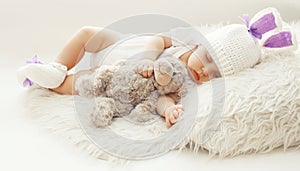 Baby comfort! Sweet infant at home sleeping with teddy bear
