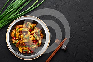 Baby Corn Manchurian dry looks like Schezwan Baby Corn in black bowl at dark slate background