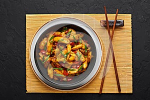 Baby Corn Manchurian dry looks like Schezwan Baby Corn in black bowl at dark slate background