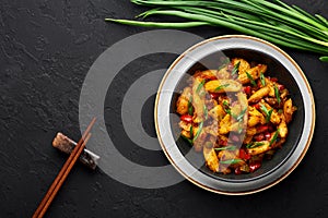 Baby Corn Manchurian dry looks like Schezwan Baby Corn in black bowl at dark slate background